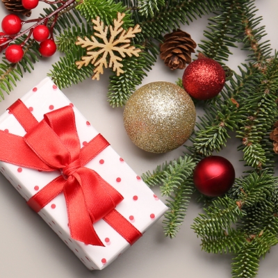 holiday present with greenery and ornaments